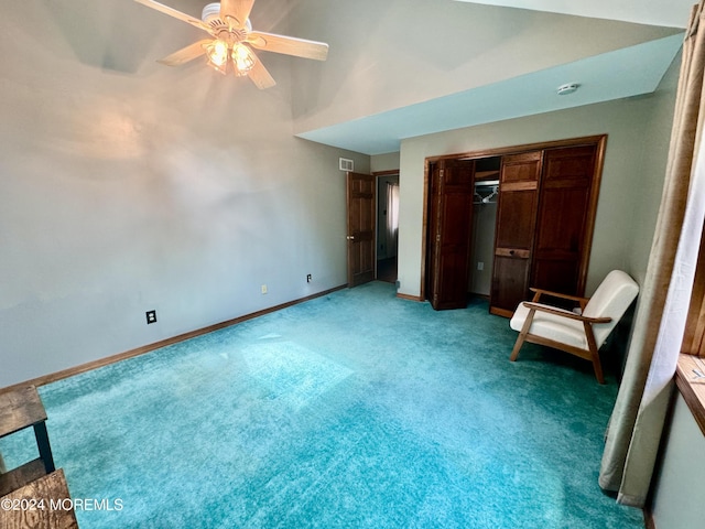 unfurnished bedroom featuring carpet flooring, ceiling fan, lofted ceiling, and a closet