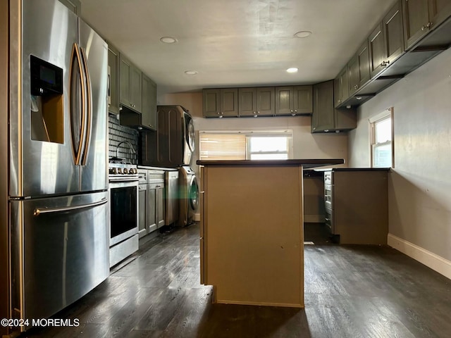 kitchen with a center island, dark hardwood / wood-style floors, decorative backsplash, stacked washing maching and dryer, and appliances with stainless steel finishes