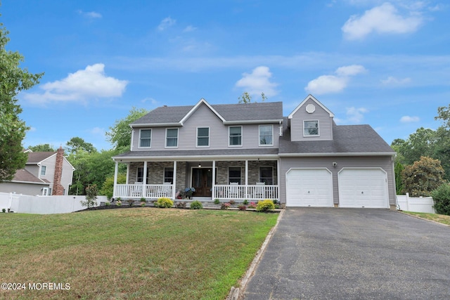 view of front facade featuring a porch, a garage, and a front yard