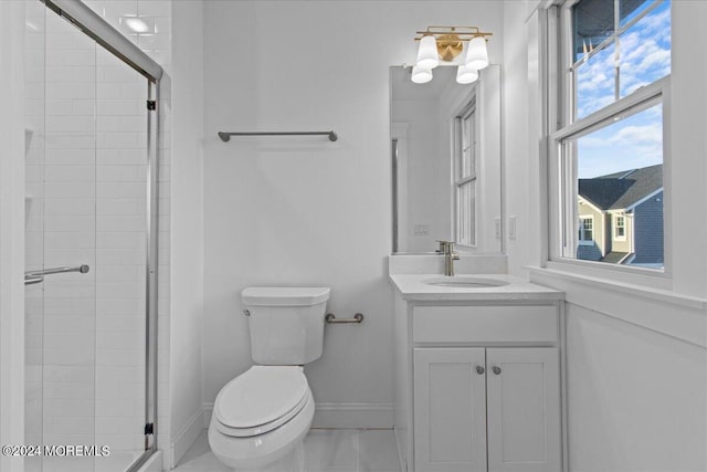 bathroom with vanity, toilet, baseboards, and a stall shower