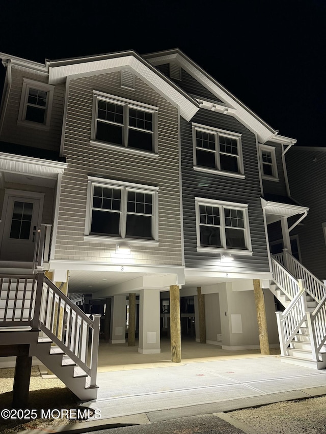 view of front facade featuring stairway and a carport