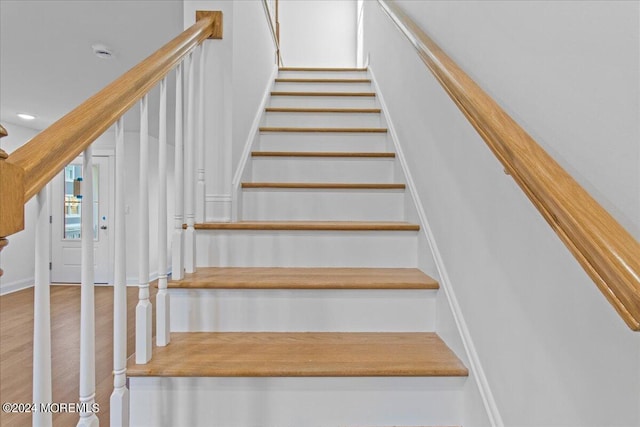 staircase with hardwood / wood-style flooring