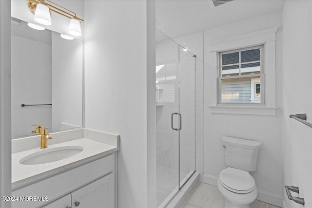 bathroom with vanity, a shower with shower door, tile patterned floors, and toilet