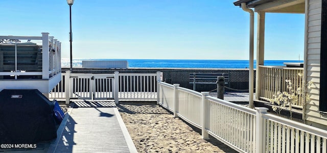 balcony with a water view and grilling area