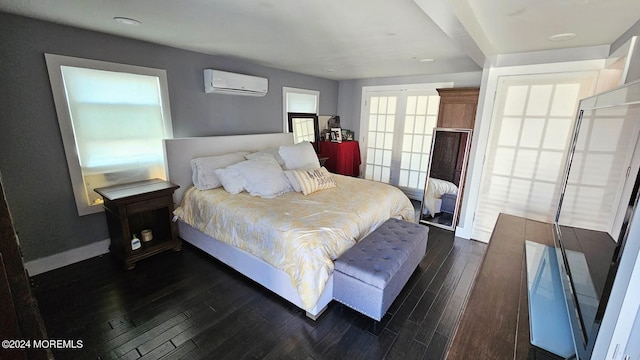 bedroom with a wall mounted air conditioner and dark hardwood / wood-style floors