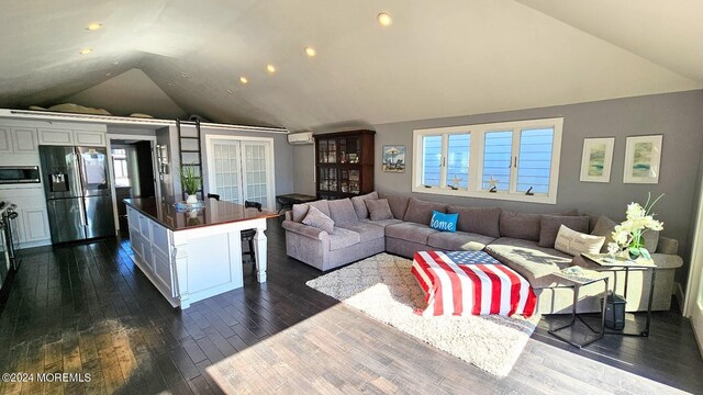 living room with lofted ceiling, dark wood-type flooring, and a wall mounted AC