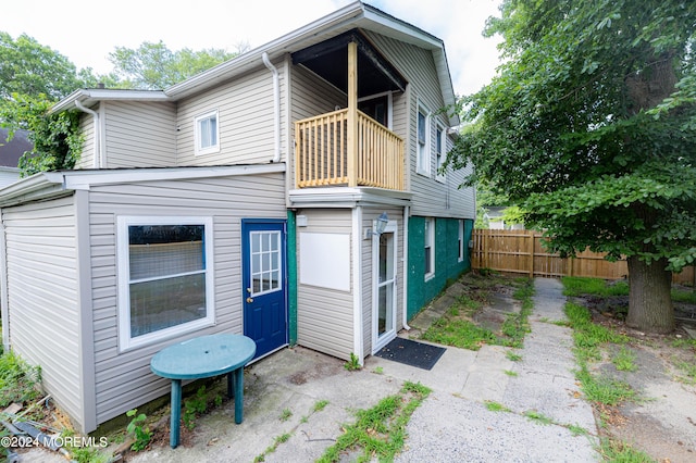 rear view of property with a balcony