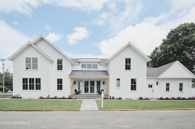 view of front of house featuring a front lawn and covered porch