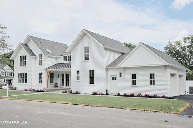 view of front of home featuring a garage and a front yard