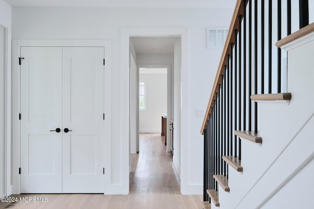 stairway with hardwood / wood-style floors