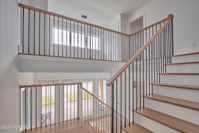 staircase with a towering ceiling