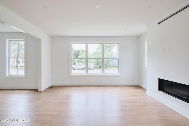 unfurnished living room with light hardwood / wood-style flooring