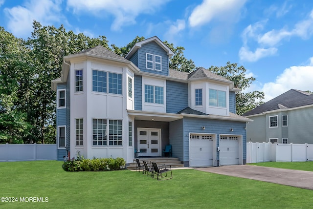 view of front facade with a garage and a front lawn