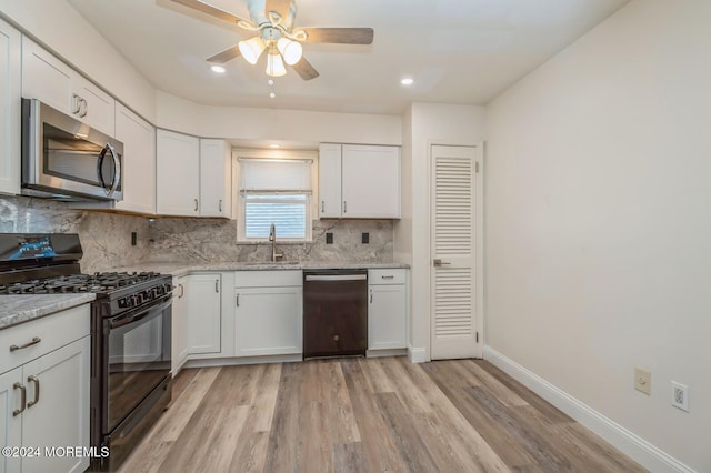 kitchen with sink, stainless steel appliances, light hardwood / wood-style flooring, backsplash, and white cabinets