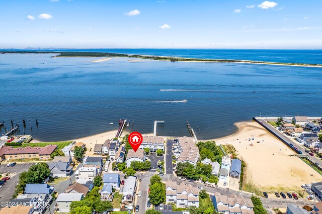 aerial view with a water view and a beach view