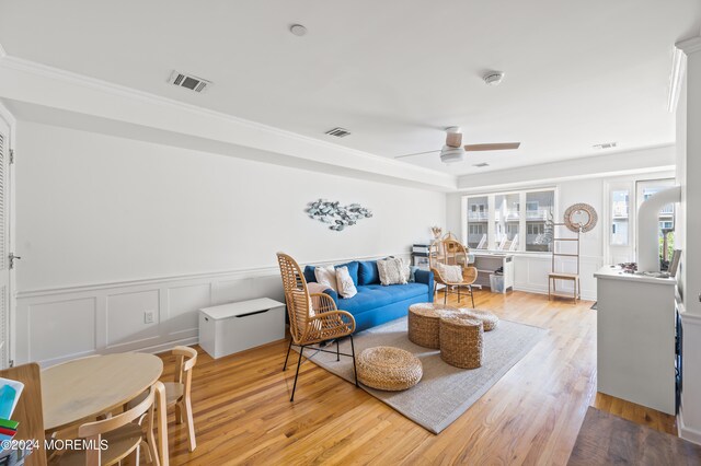 living room featuring ceiling fan and light hardwood / wood-style floors