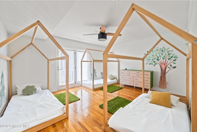 bedroom with wood finished floors, a ceiling fan, and vaulted ceiling