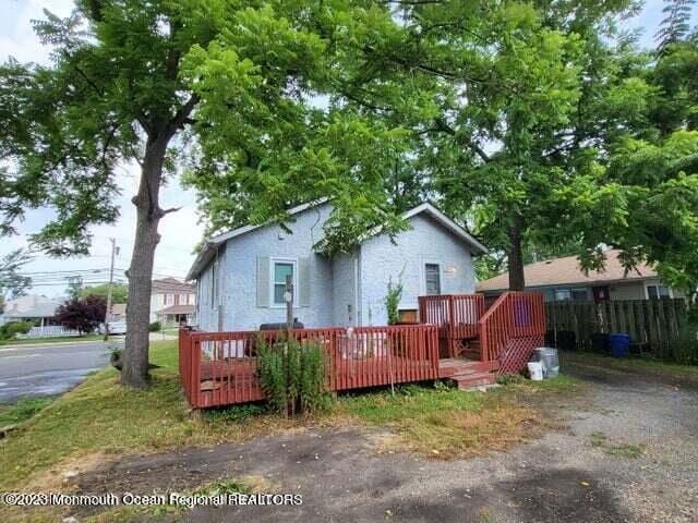 rear view of house featuring a deck