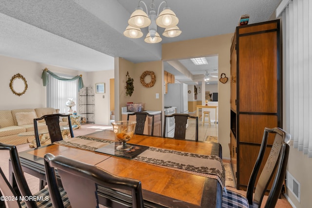 dining room with a notable chandelier and a textured ceiling