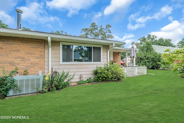 view of home's exterior featuring central AC and a lawn