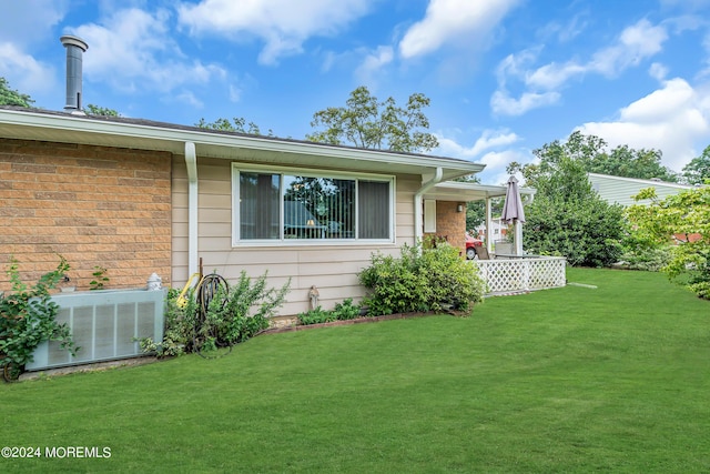 exterior space with a yard and central AC