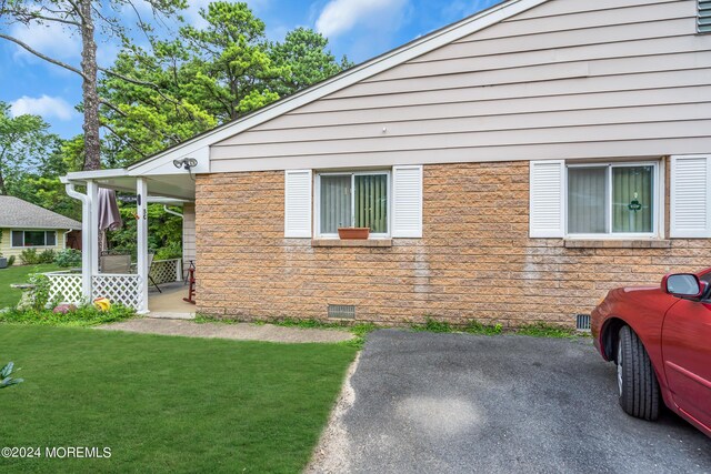 view of side of property with a lawn