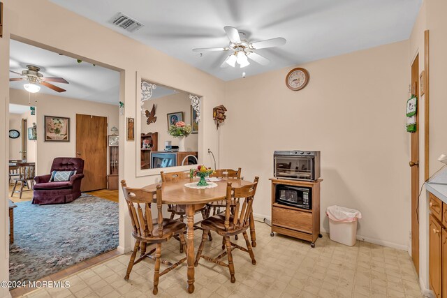 dining room featuring light tile patterned flooring and ceiling fan