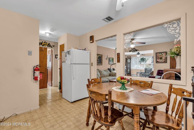 dining room with light tile patterned floors and ceiling fan