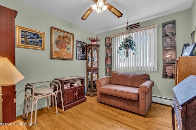 sitting room with a baseboard radiator, ceiling fan, and light hardwood / wood-style flooring