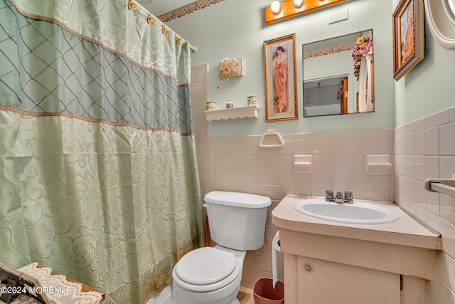 bathroom featuring vanity, toilet, decorative backsplash, and tile walls