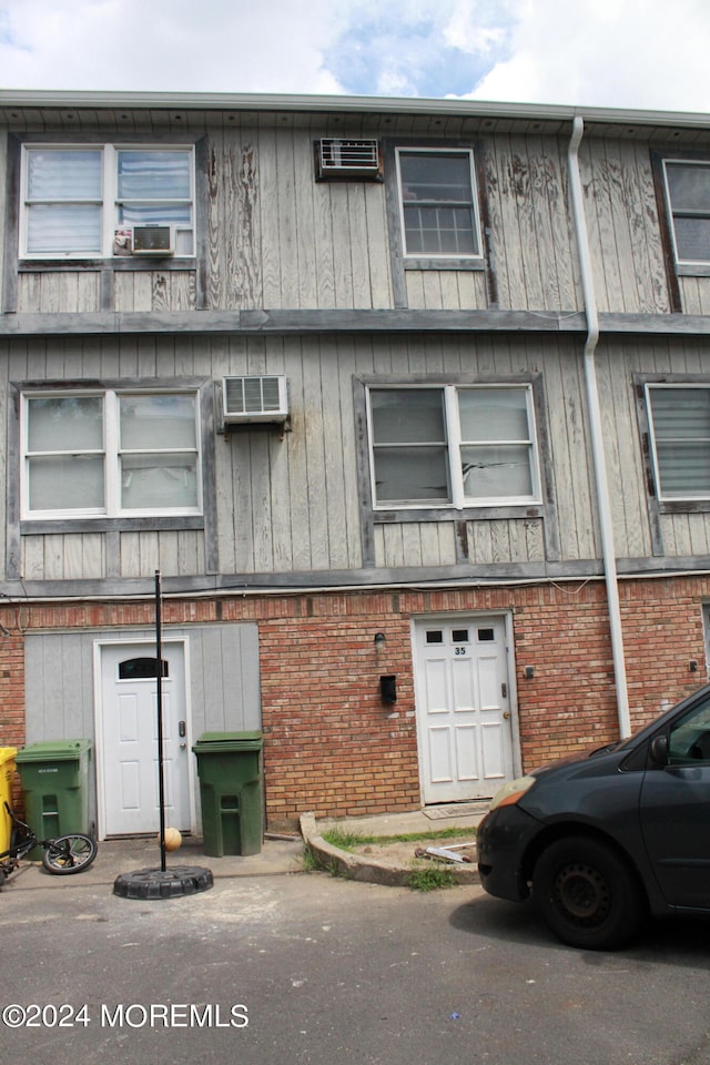 view of building exterior featuring a wall unit AC