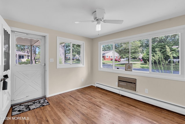 entryway with ceiling fan, light hardwood / wood-style flooring, and a baseboard heating unit