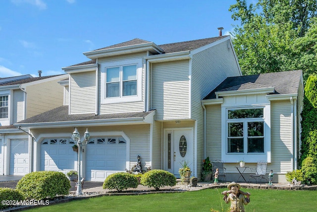 view of front of property featuring a garage and a front yard