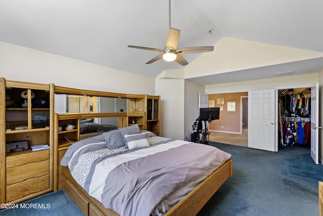 bedroom featuring vaulted ceiling, ceiling fan, dark colored carpet, a walk in closet, and a closet