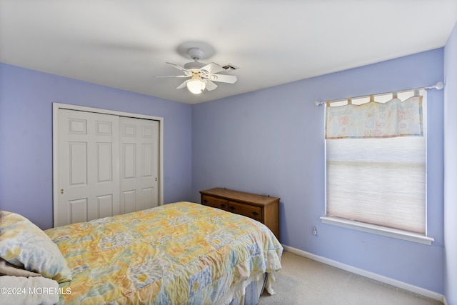 bedroom featuring carpet floors, a closet, and ceiling fan