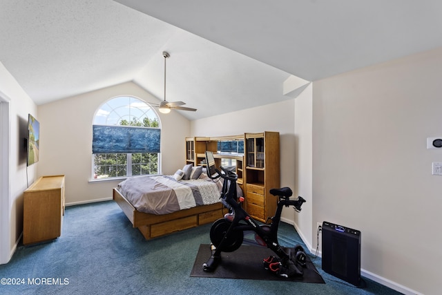 bedroom featuring dark colored carpet, vaulted ceiling, and ceiling fan