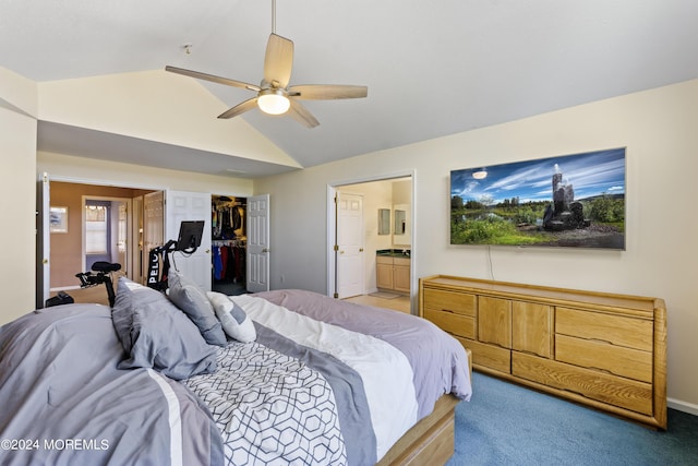 carpeted bedroom featuring ceiling fan, ensuite bath, a walk in closet, a closet, and lofted ceiling