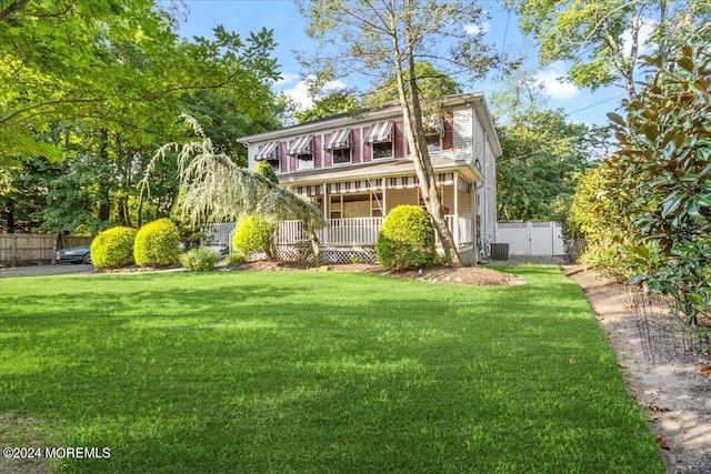 view of front of house with a front yard and covered porch