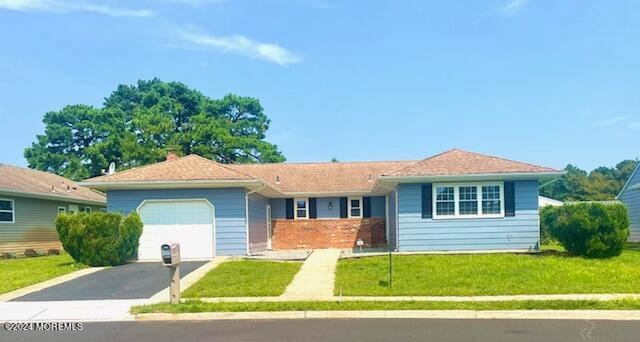 ranch-style home with a garage and a front yard