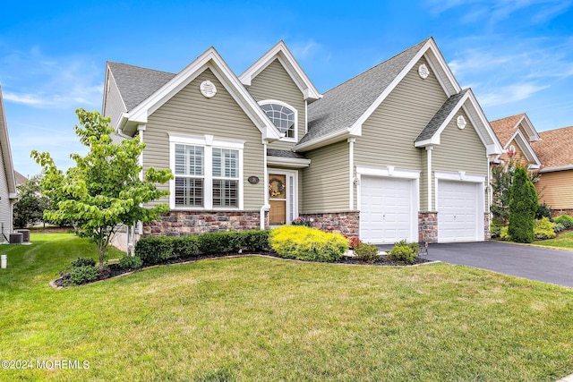 view of front facade featuring central AC unit, a garage, and a front lawn