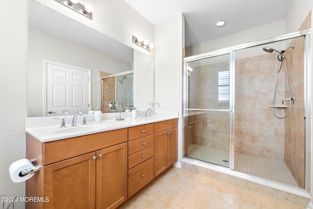 bathroom featuring a shower with door, tile patterned flooring, and vanity