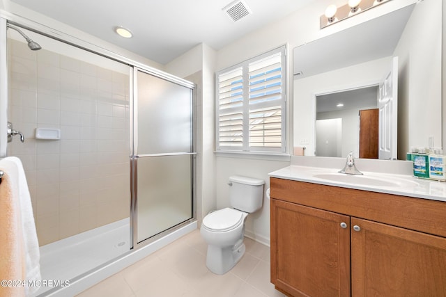 bathroom with toilet, tile patterned flooring, a shower with shower door, and vanity