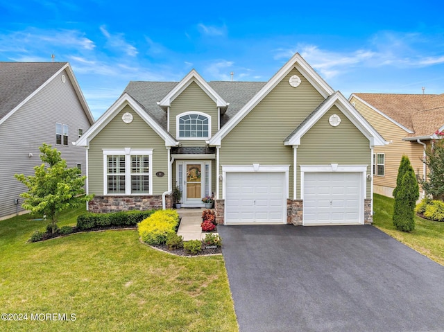 view of front of house with a garage and a front yard