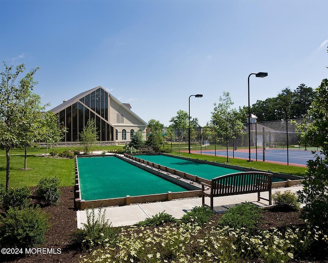 view of pool with tennis court