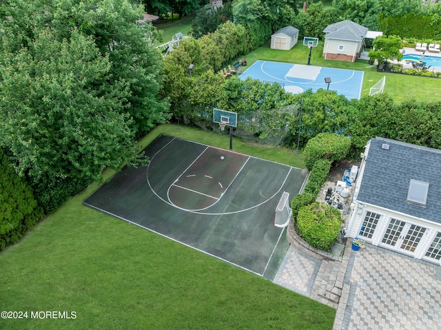 view of basketball court featuring a yard