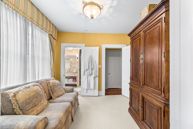 living area featuring light carpet