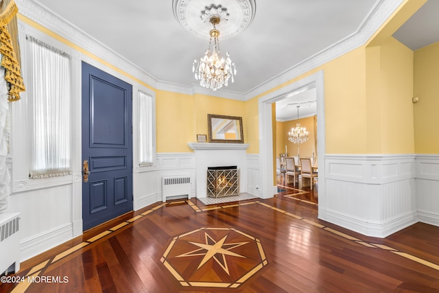 interior space with wood-type flooring, radiator, crown molding, and a chandelier