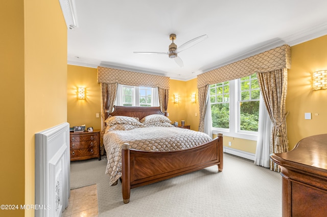 carpeted bedroom with ornamental molding, a baseboard heating unit, and ceiling fan