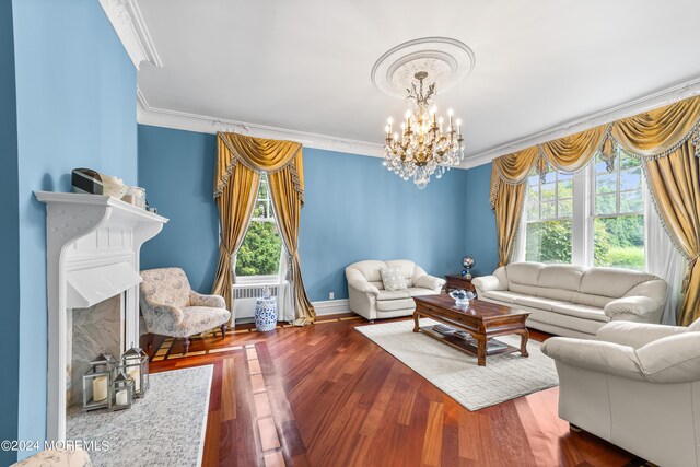 living room featuring ornamental molding, radiator, an inviting chandelier, and wood-type flooring