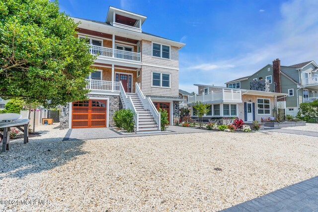 view of front of house with a garage and a balcony